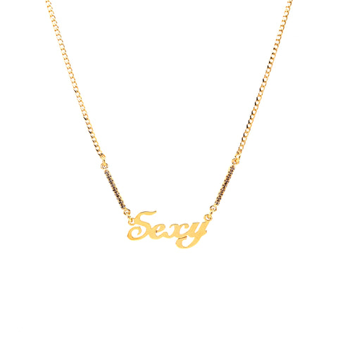 A sleek and sophisticated Cuban link necklace showcases a "Sexy" pendant with cursive lettering, crafted from 14k gold-filled material. This nickel-free chain is accented with small black beads on each side against a simple white backdrop.